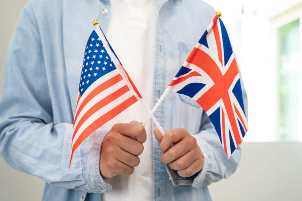 Learn English language, Asian teenage student hold book with flag in course at school.